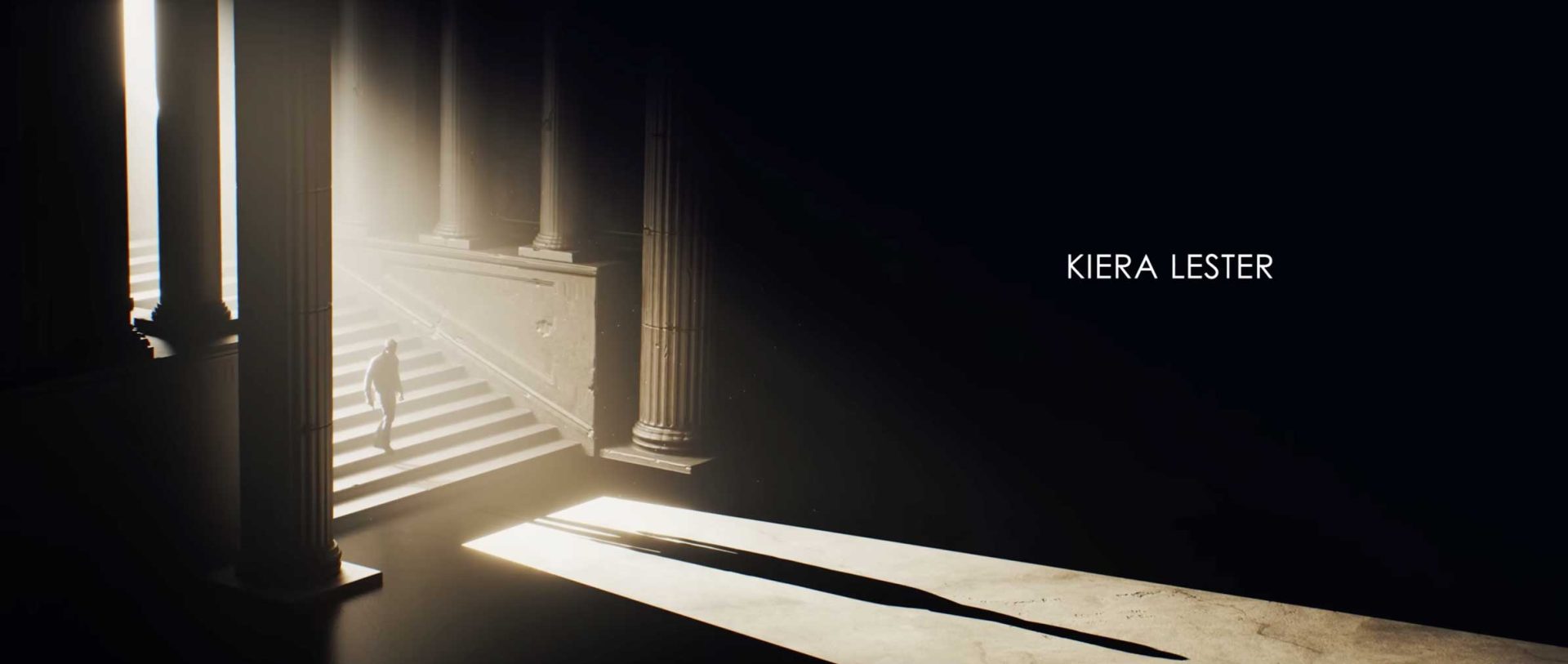 A person ascends a grand, sunlit staircase beside large pillars, casting long shadows on the floor—evoking a Game Title Sequence. The name Kiera Lester appears in white text on the right side of the dark background. Frame from Stash Magazine article.