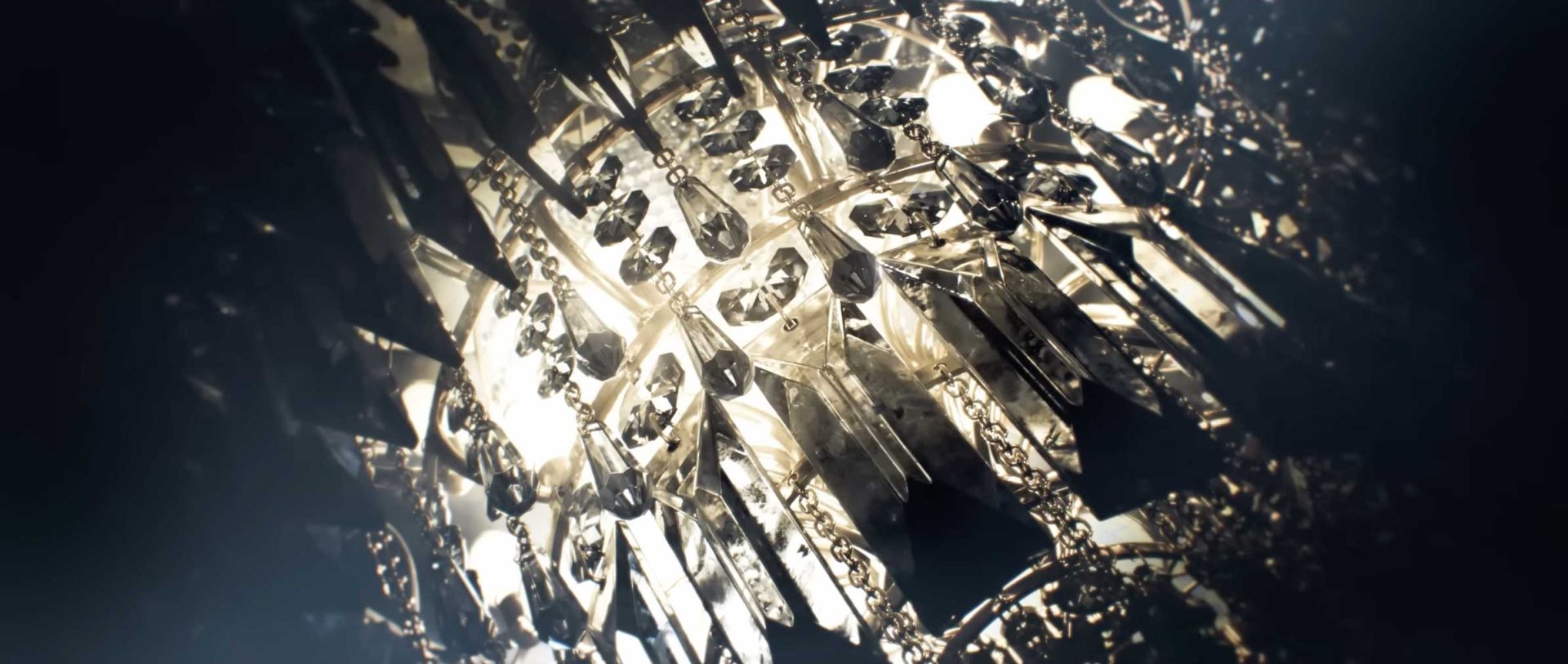 Close-up view of a crystal chandelier with hanging glass prisms and intricate metalwork, illuminated by warm light, evoking sparkling reflections and the dramatic elegance of a Game Title Sequence. Frame from Stash Magazine article.