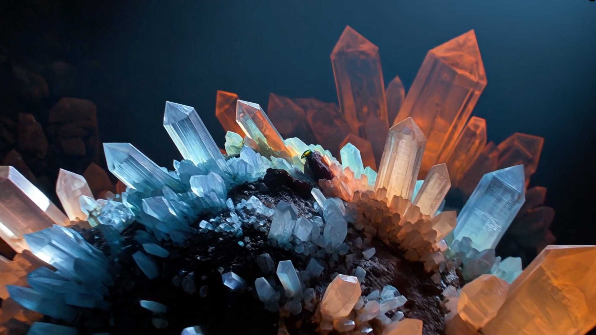 Large, colorful crystals—blue, white, and orange—grow out of a dark, rocky surface in this radiant AI-Generated Title Sequence by Beeldmotion for EXO, with vibrant angles dramatically illuminated against a deep background. Frame from Stash Magazine article.