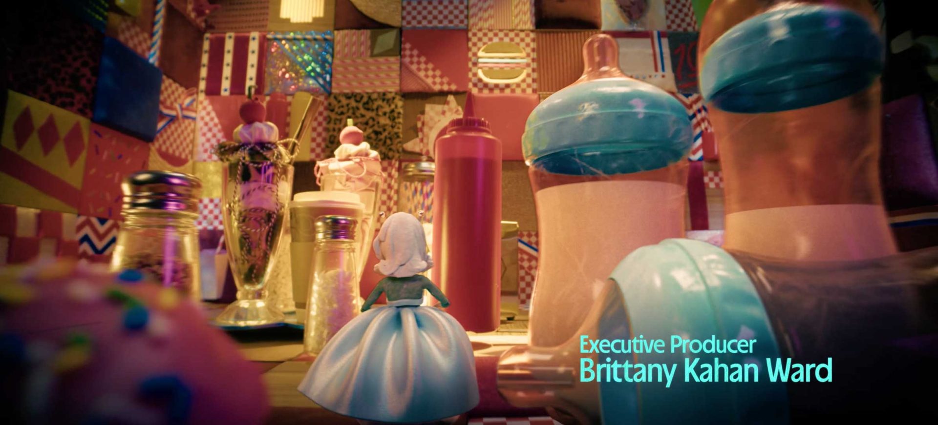 A doll in a blue dress faces oversized baby bottles and milkshakes in a colorful, patterned room. Text reads: Executive Producer Brittany Kahan Ward. Inspired by A24’s Margo's Got Money Troubles on Apple TV. Frame from Stash Magazine article.