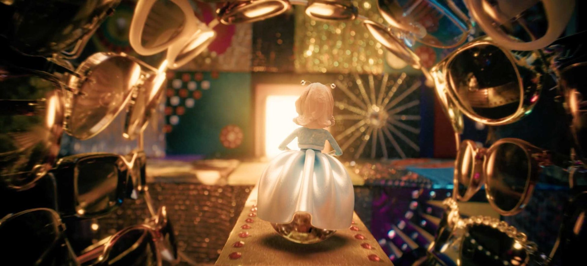 A small blonde doll in a blue dress stands on a glittery platform, facing a brightly lit opening at the end of a tunnel lined with sunglasses and shiny objects—much like a scene from Margo's Got Money Troubles Titles on Apple TV by Peter Anderson Studio. Frame from Stash Magazine article.