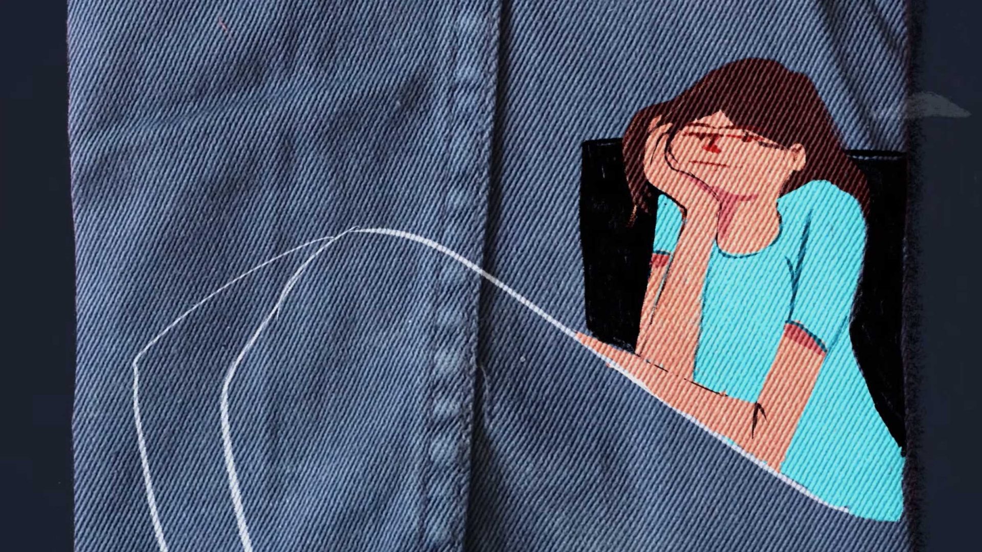 An embroidered illustration by Yegane Moghaddam on denim fabric shows a person with glasses, part of Our Uniform series, resting their head on one hand in a light blue shirt beside a white stitched outline of a leg. Frame from Stash Magazine article.