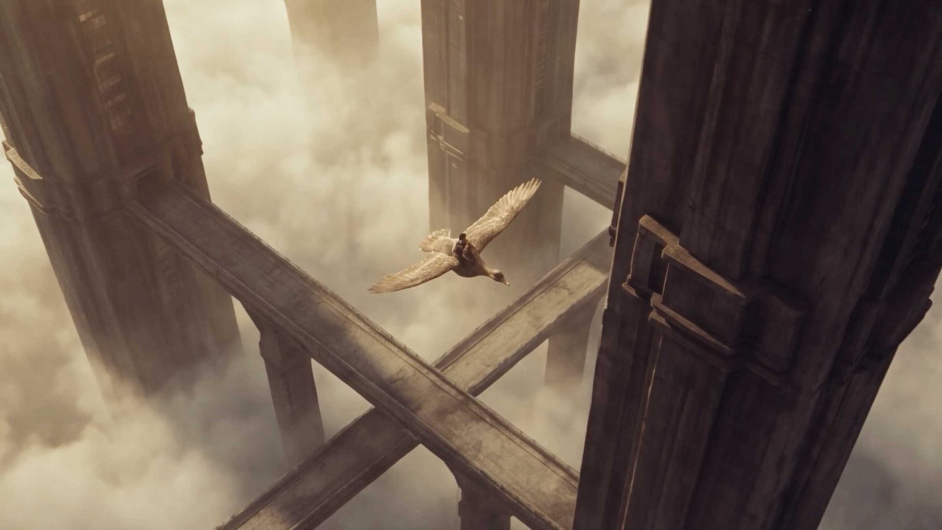 A small figure rides a large bird in Brent Bonacorso’s short film, flying between towering stone structures connected by bridges above the clouds. Frame from Stash Magazine article.