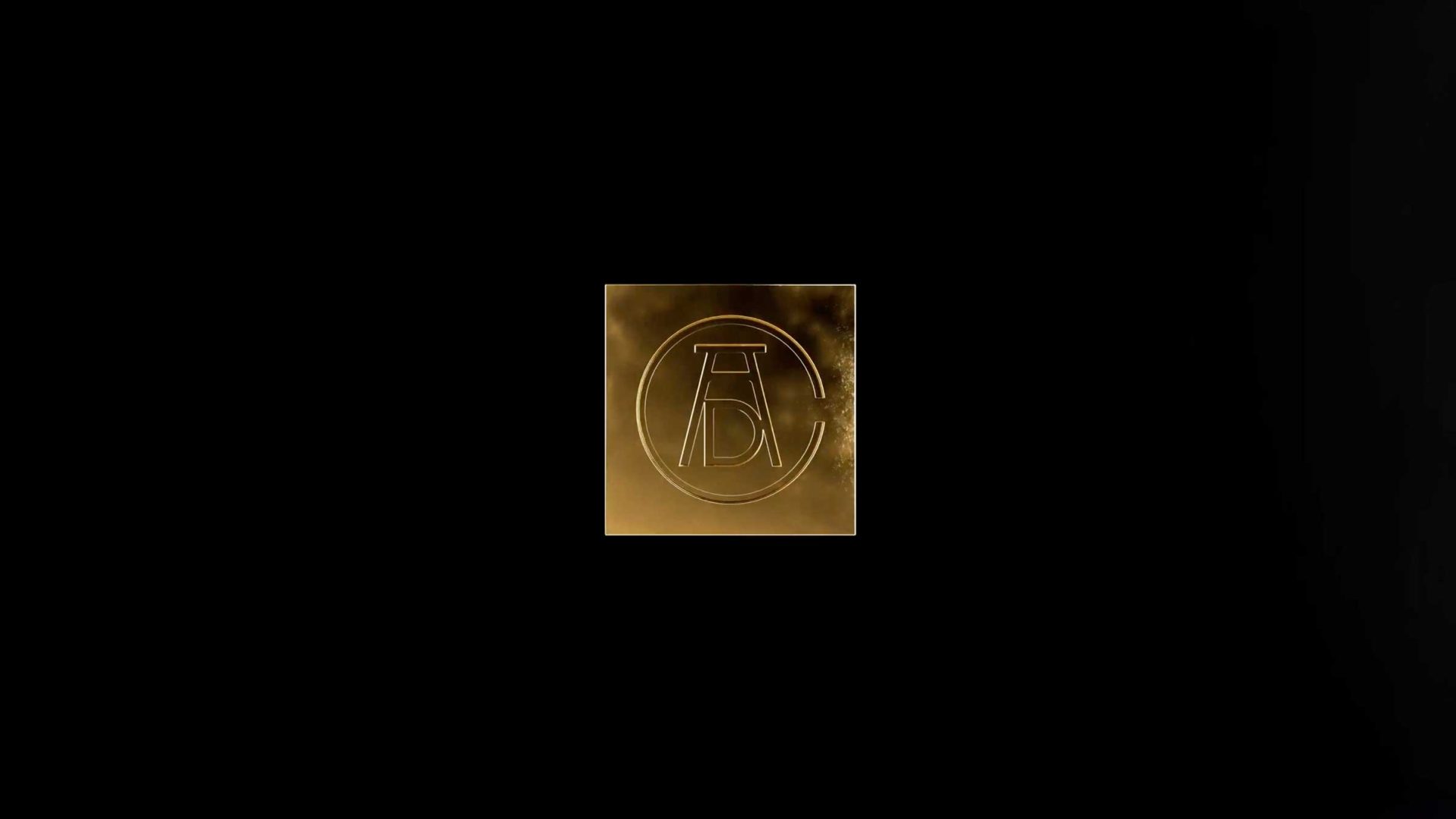 A gold square emblem on a black background featuring a stylized AD monogram inside a circle, representative of the ADC Annual Awards. Frame from Stash Magazine article.