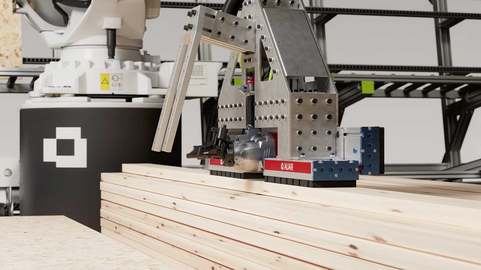 A robotic arm with a metallic gripper is placing wooden planks onto a stack in an industrial setting, with metal shelving and equipment in the background, as featured in the AUAR Robot MicroFactories launch film by XO3D. Frame from Stash Magazine article.