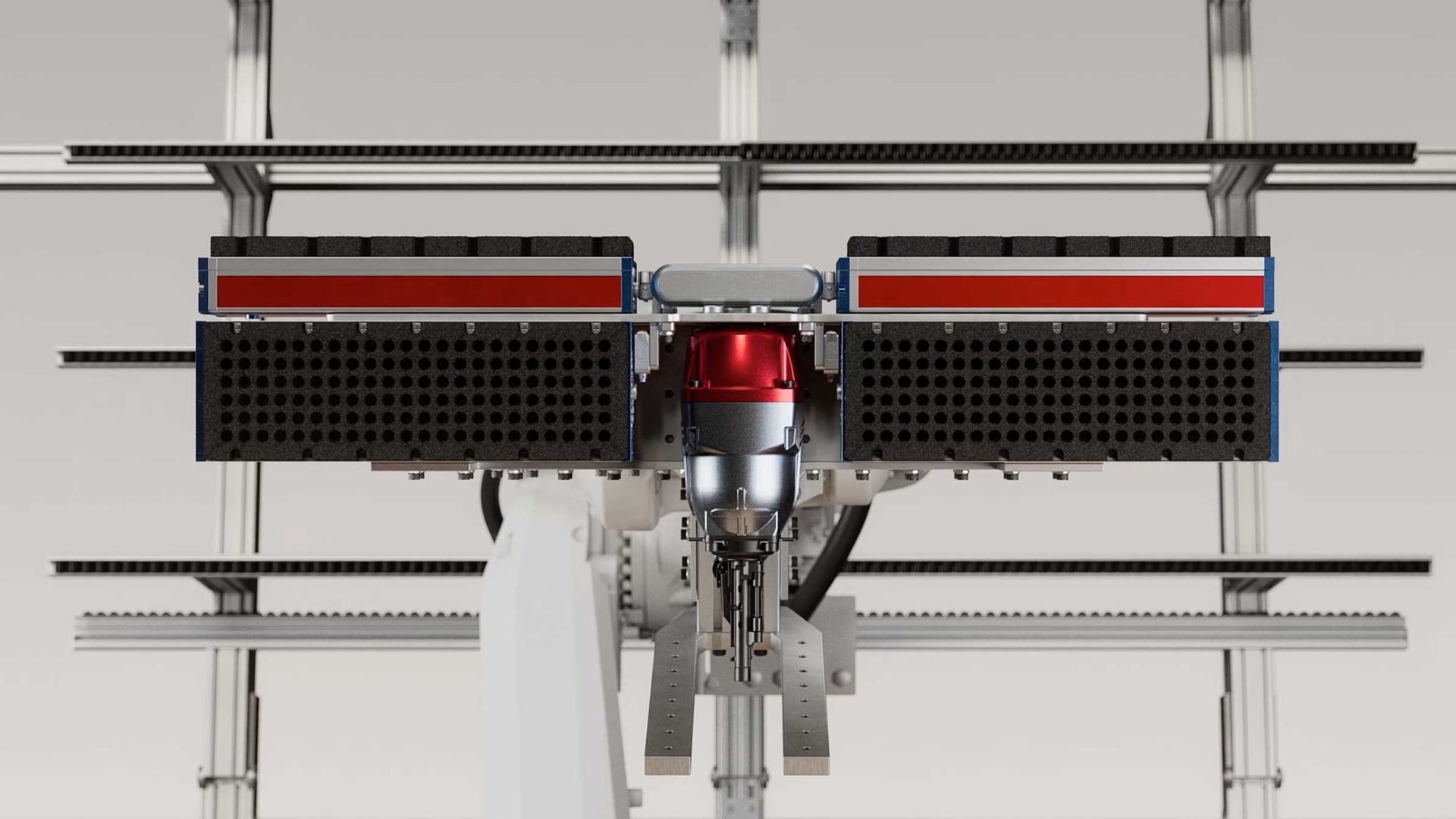 Front view of a robotic arm from XO3D, featuring a red and silver central unit, flanked by two rectangular black and red panels, with metal rails in the background—ideal for integration into Robot MicroFactories. Frame from Stash Magazine article.