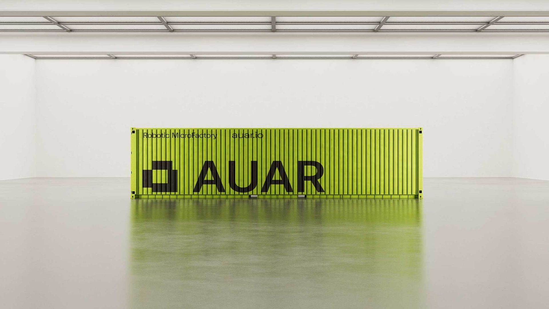 A bright yellow shipping container with AUAR in large black letters stands in a spacious, empty white room with a shiny floor and a minimalist ceiling, featured prominently in the AUAR Robot MicroFactories launch film by XO3D. Frame from Stash Magazine article.