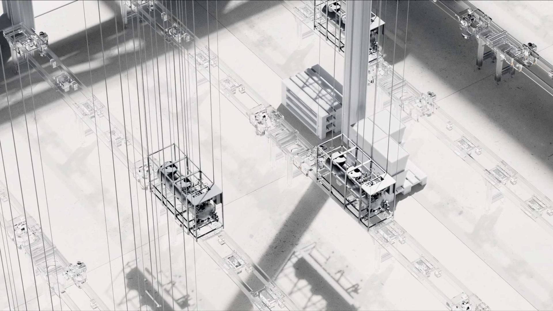A top-down view of multiple industrial elevator platforms suspended by cables, moving along tall vertical tracks in a bright, minimalistic, and shadow-filled setting—perfectly capturing the dynamic innovation and sleek visuals suited for a Stylo Creative brand film. Frame from Stash Magazine article.