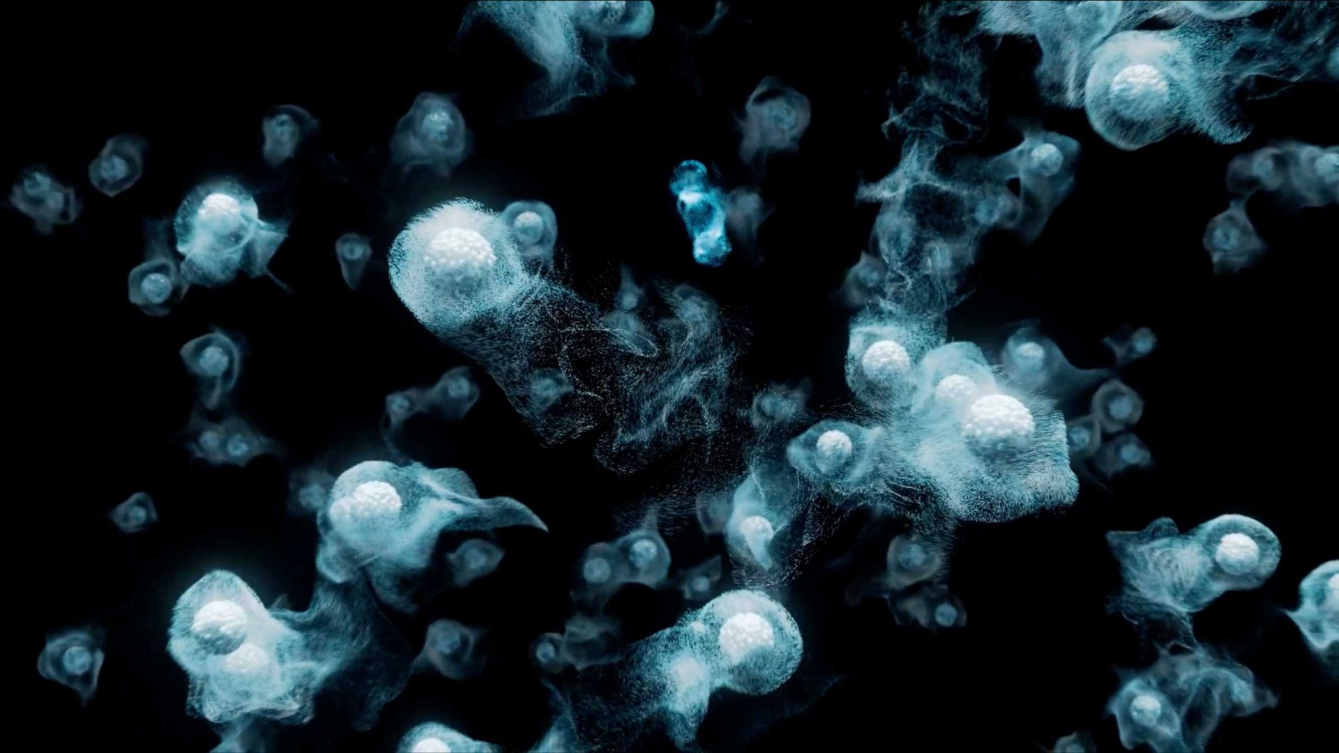 Translucent, glowing jellyfish-like shapes drift against a dark background, creating an ethereal underwater effect with swirling blue and white light patterns—an otherworldly visual experience reminiscent of the “Aalo Atomic Energy Without Limits” brand film by Stylo Creative. Frame from Stash Magazine article.