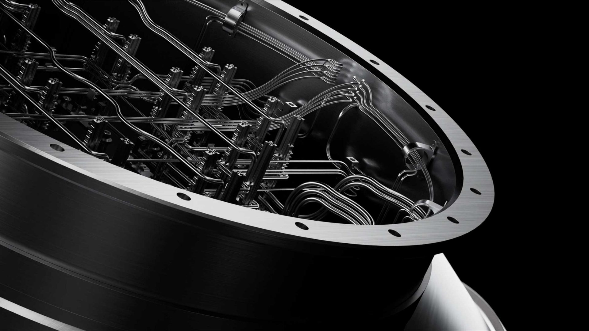 Close-up of a metallic, circular structure with intricate wires and components inside, resembling part of a high-tech machine or scientific instrument, against a black background—evoking the futuristic visuals seen in the Aalo Atomic Energy Without Limits brand film by Stylo Creative. Frame from Stash Magazine article.