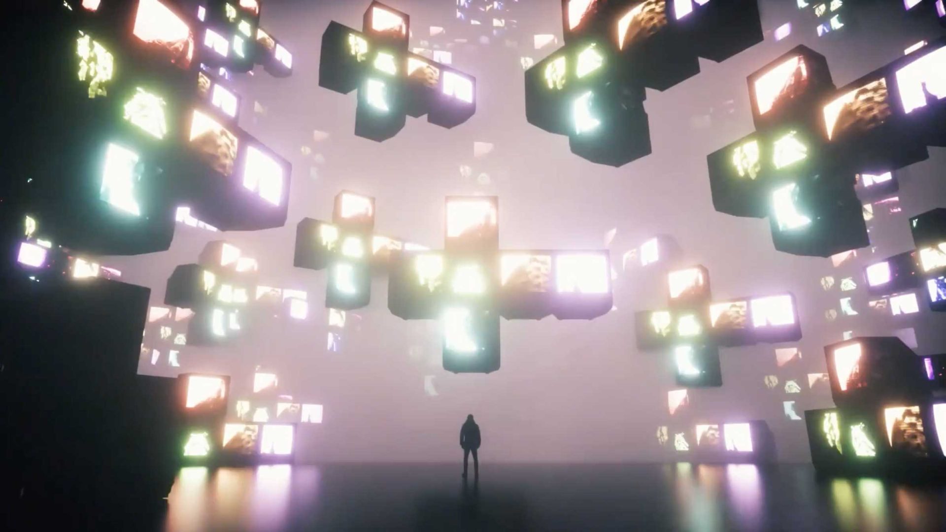 A person stands alone in a dark space, surrounded by floating illuminated cubes with glowing screens—a futuristic, surreal atmosphere echoing Afonso Amaro and João Vaz Oliveira’s visionary direction for The Atlas Festival 2026 titles. Frame from Stash Magazine article.