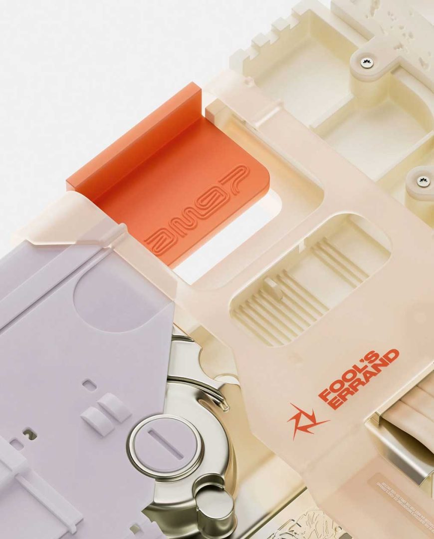 A close-up of abstract, pastel-colored plastic parts assembled together, featuring engraved logos including AM9P in orange and Fool’s Errand in red on a cream surface. The clean, minimalistic style evokes the innovative spirit of Air Max '97. Frame from Stash Magazine article.