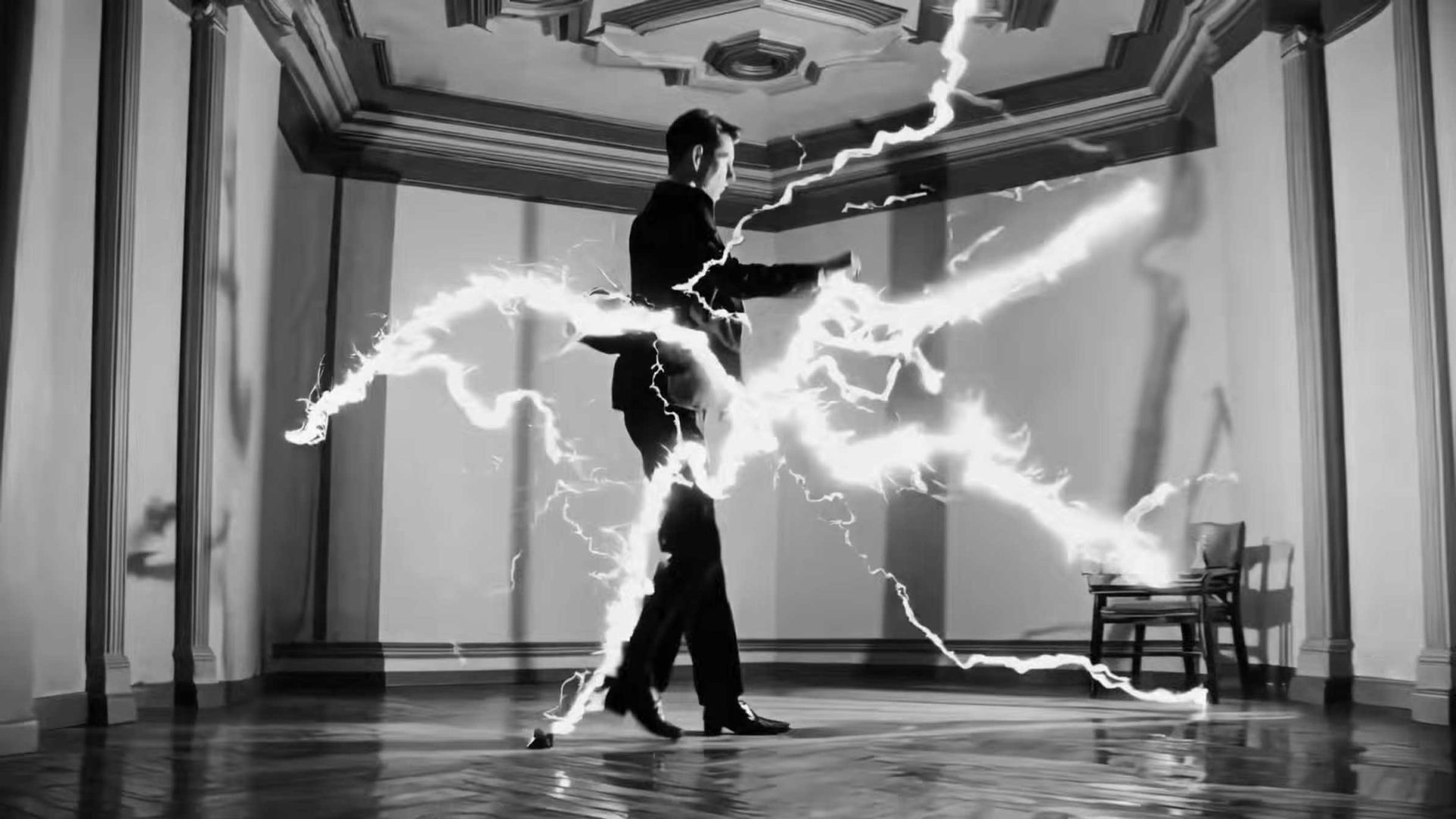A man in a suit stands in a formal room as bright, jagged bolts of electricity—reminiscent of Solid Light From Space—surround him. The room has ornate ceilings, and a single chair sits in the corner. The dramatic black and white scene evokes the surreal, cinematic style of Alessandro Bavari. Frame from Stash Magazine article.