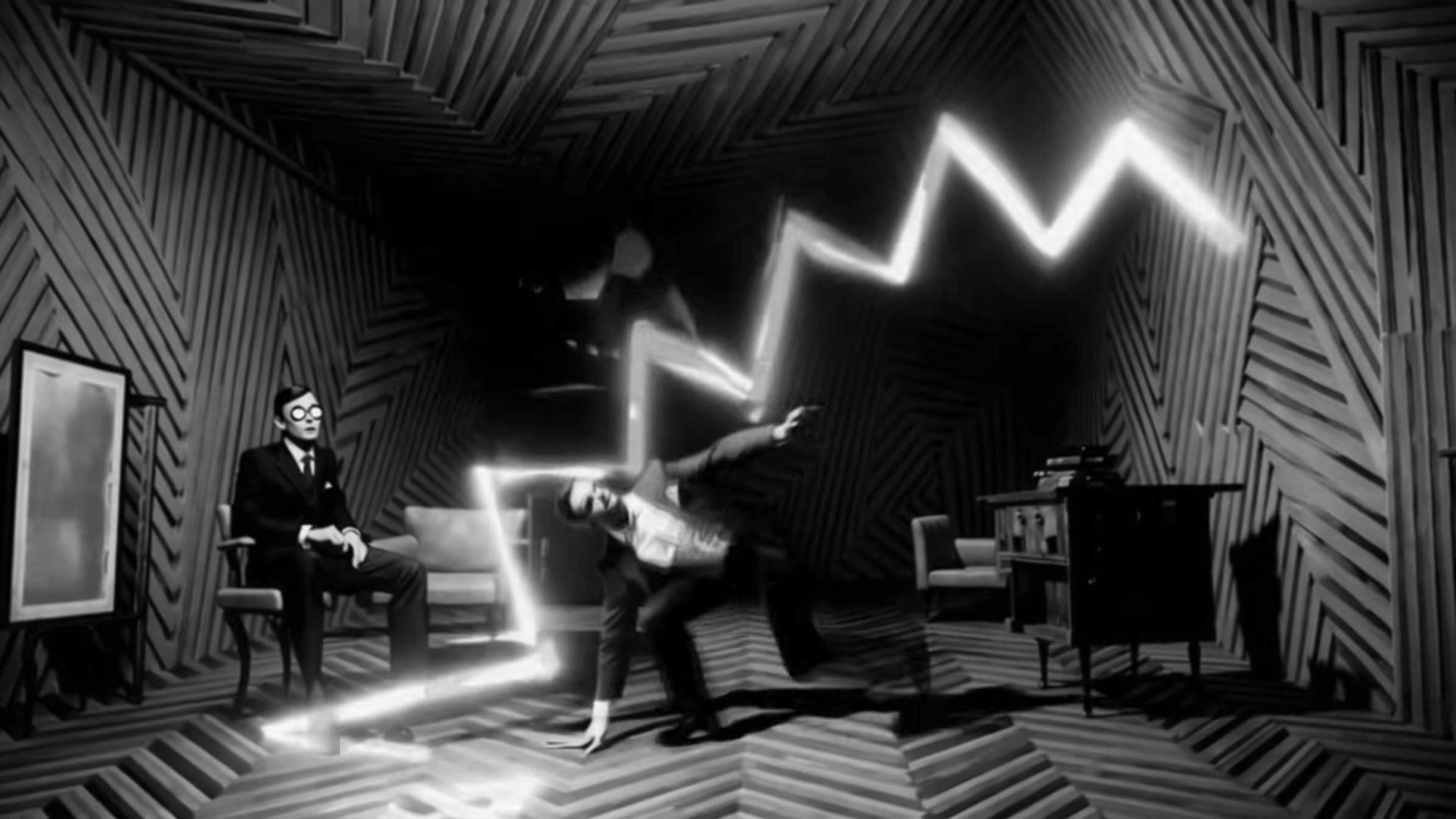 A surreal, zig-zag lightning bolt—reminiscent of Solid Light From Space—illuminates a chevron-patterned room; one person in a suit sits calmly while another dodges the bolt dramatically. The scene, evocative of Alessandro Bavari’s stark aesthetics, is in black and white with distorted, geometric walls and floor. Frame from Stash Magazine article.