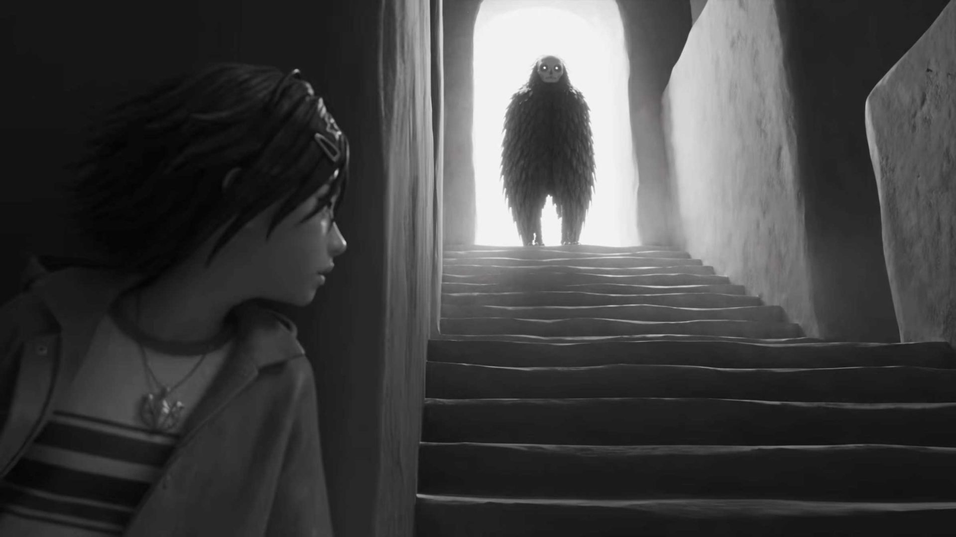A young person looks toward a staircase where a tall, dark, furry creature with a pale face from The Surrender stands silhouetted in a bright doorway. Frame from Stash Magazine article.