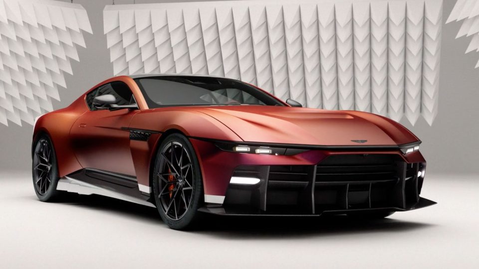 A sleek, modern sports car in metallic burnt orange is parked in a studio with geometric acoustic panels on the walls, highlighting its sharp lines and aerodynamic design—captured with cinematic flair reminiscent of the Aston Martin Valen Launch film by Tomorrow Bureau. Frame from Stash Magazine article.