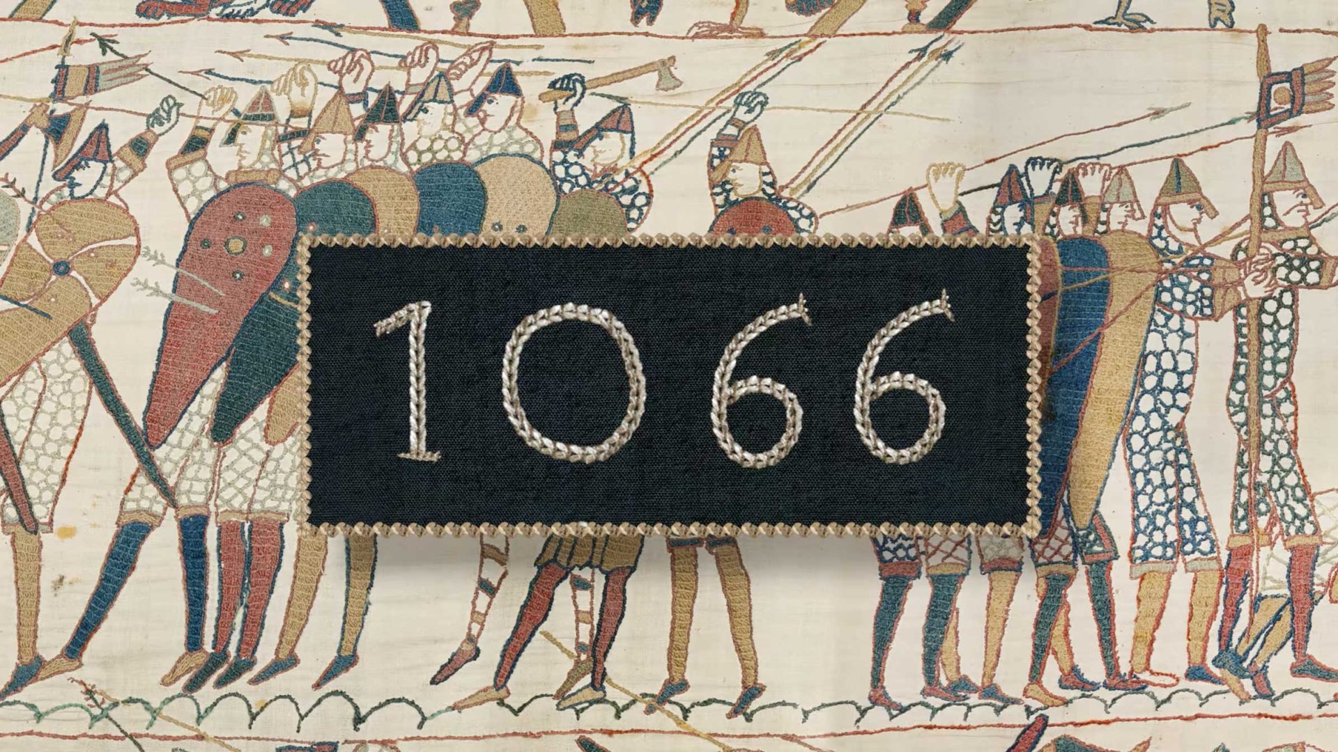 The number 1066 is stitched on a black rectangle over a section of the Bayeux Tapestry, where soldiers with shields and weapons appear as if caught in a moment of medieval magic. Frame from Stash Magazine article.