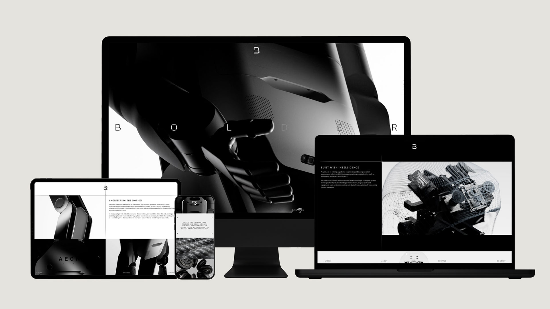 A desktop monitor, laptop, tablet, and smartphone display a futuristic black-and-white website featuring a robotic figure and bolder typography, showcasing motion-inspired responsive design across multiple devices. Frame from Stash Magazine article.
