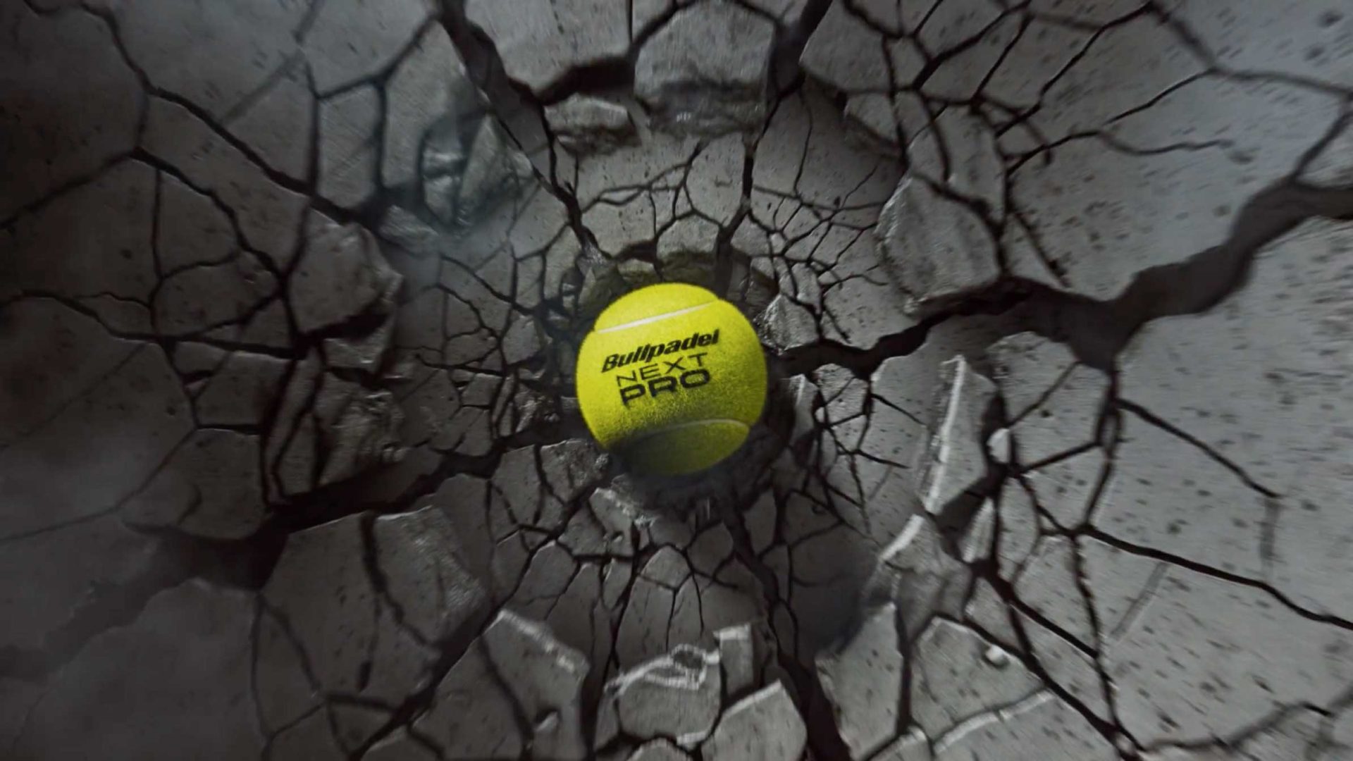 A Bullpadel NEXT PRO tennis ball centered in a cracked, circular crater created by a Bullpadel Xplo 02. Frame from Stash Magazine article.