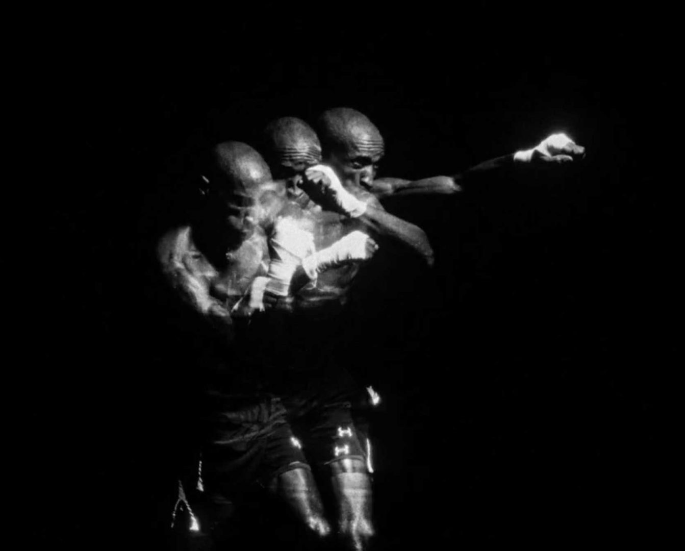 A black and white photo shows a boxer in motion, captured in three overlapping positions as he throws a punch against a dark background—a powerful visual that evokes the enduring spirit of "African Time," reminiscent of Zee Ntuli’s cinematic storytelling. Frame from Stash Magazine article.