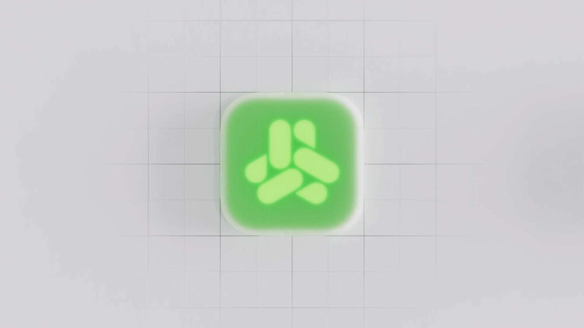 A rounded square green button with a glowing geometric white symbol in the center, resembling interlocking shapes, is set against a light gray background with a faint grid pattern—evoking the sleek visual style seen in the CuspAI Brand Film by Wes Cockx. Frame from Stash Magazine article.
