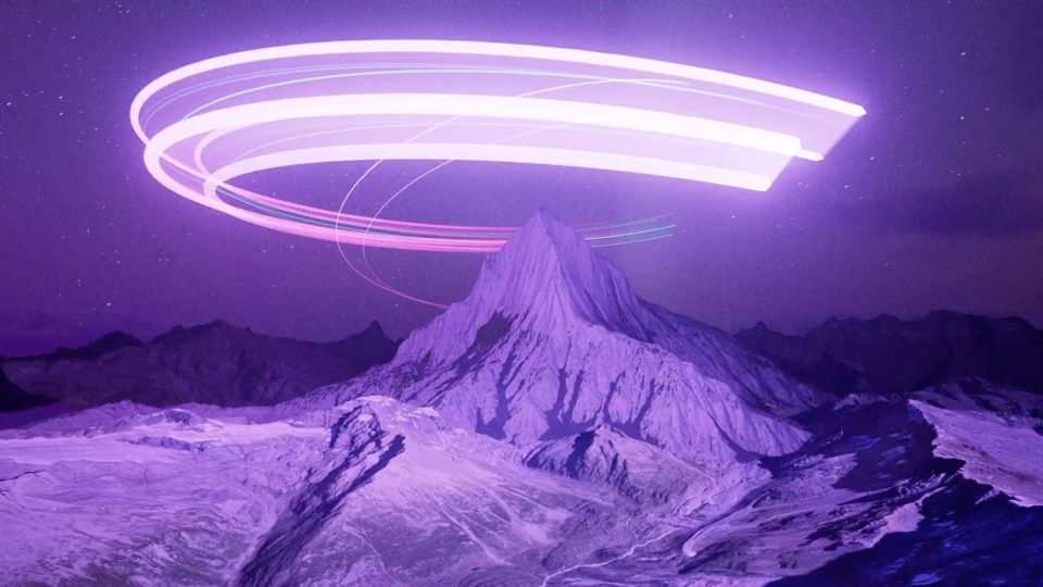 A snowy mountain peak under a purple sky with bright, curved light trails looping above, creating a surreal, futuristic atmosphere reminiscent of the DEEP GEO short film by Kim Taylor. Frame from Stash Magazine article.