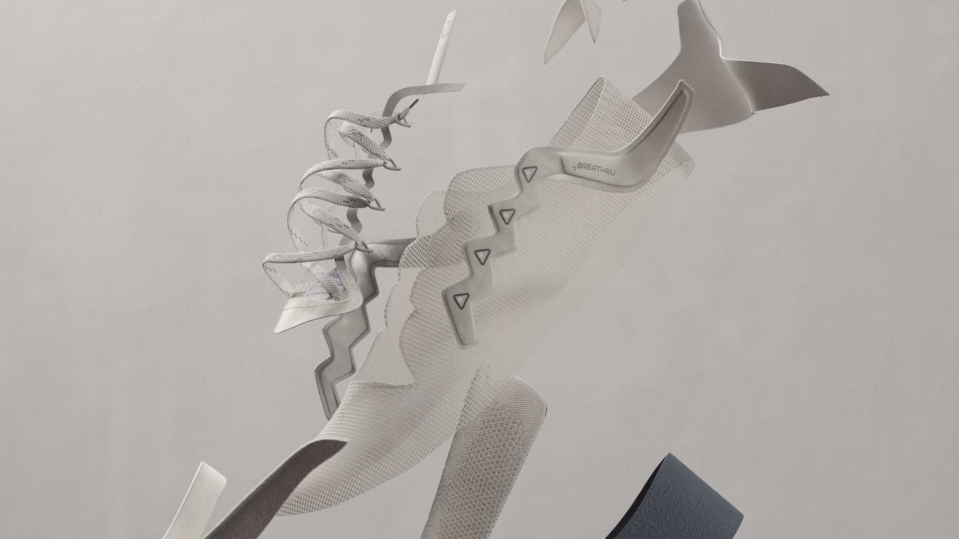 A deconstructed ECCO Biom 720 sneaker floats in midair, showcasing layers of mesh, foam, fabric, and rubber—each component separated and suspended as in a KORB product film—to reveal the shoe’s intricate inner structure against a plain gray background. Frame from Stash Magazine article.