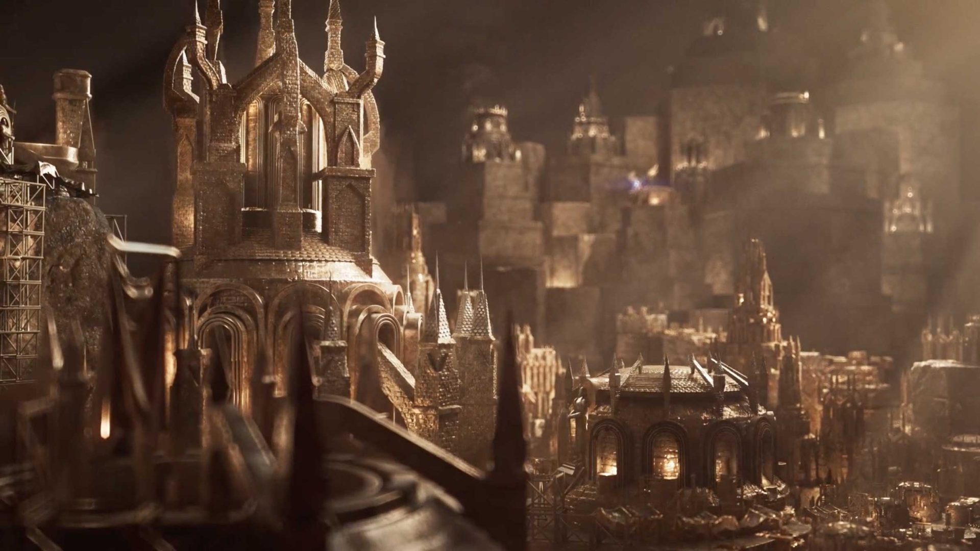 Intricately detailed model of a medieval city with golden, castle-like buildings, towers, and spires, bathed in warm light, creating a dramatic and fantastical atmosphere reminiscent of a Unit Motion Design trailer for Endless Legend 2. Frame from Stash Magazine article.