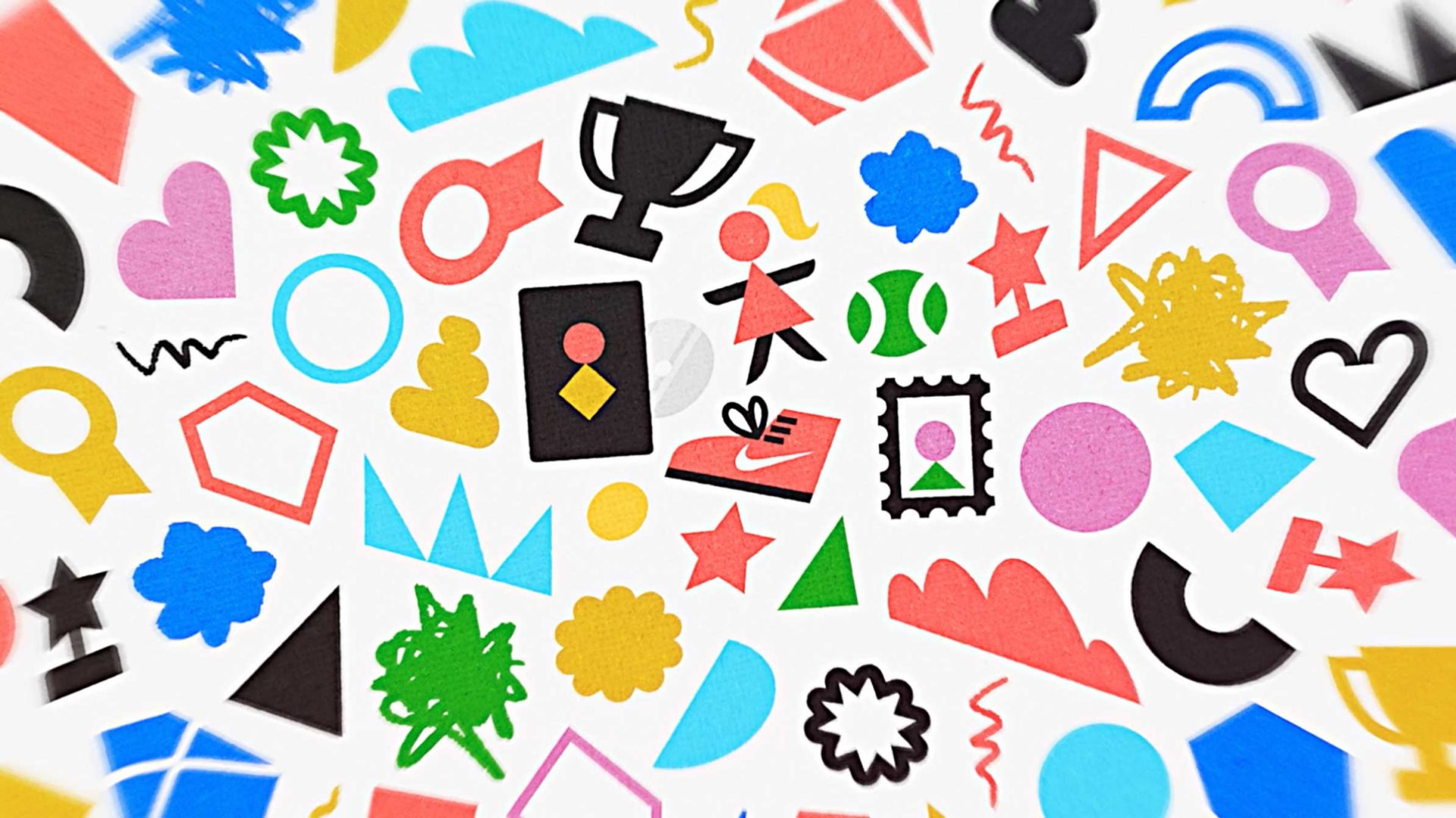 A colorful assortment of various icons, including trophies, geometric shapes, hearts, stars, clouds, and symbols—some inspired by Christine Sinclair—scattered randomly on a white background. Frame from Stash Magazine article.