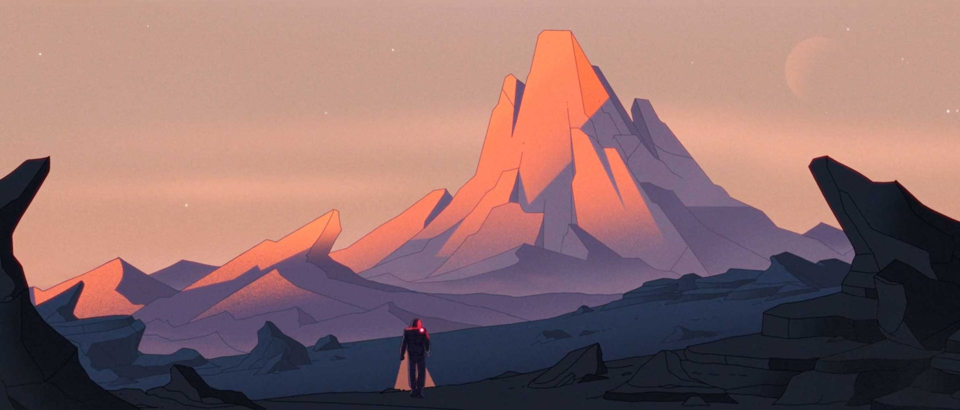 A lone figure in a cape stands on rocky terrain, gazing at a tall, jagged mountain bathed in soft pink and orange light—a quiet moment of memory and connection under the faint moon. Frame from Stash Magazine article.