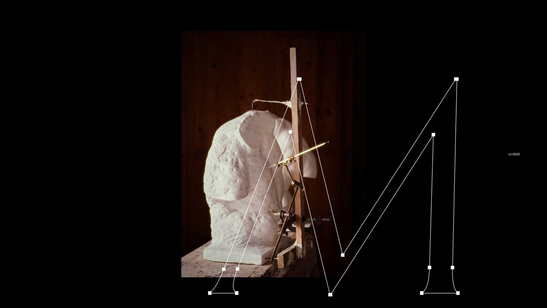A white plaster sculpture on a wooden base with a measuring tool attached, overlaid with a digital wireframe of the capital letter M and U+0053 from the Exemplar Typeface. Frame from Stash Magazine article.