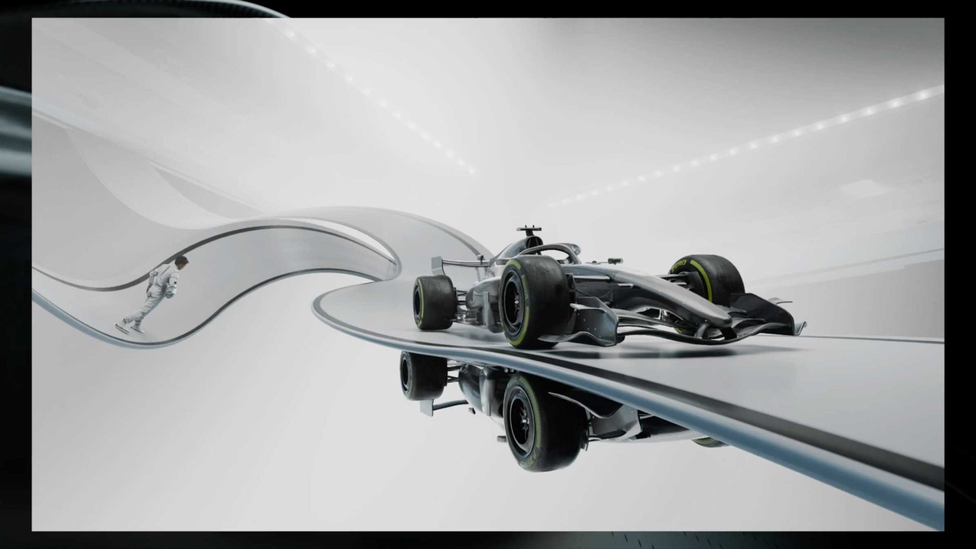 A futuristic silver Formula 1 car speeds along a twisting, elevated track in a sleek, minimalistic environment, evoking the style of the F1 2026 Opening Titles Process Reel by DissEmbargo. A figure in a racing suit walks in the background. Frame from Stash Magazine article.