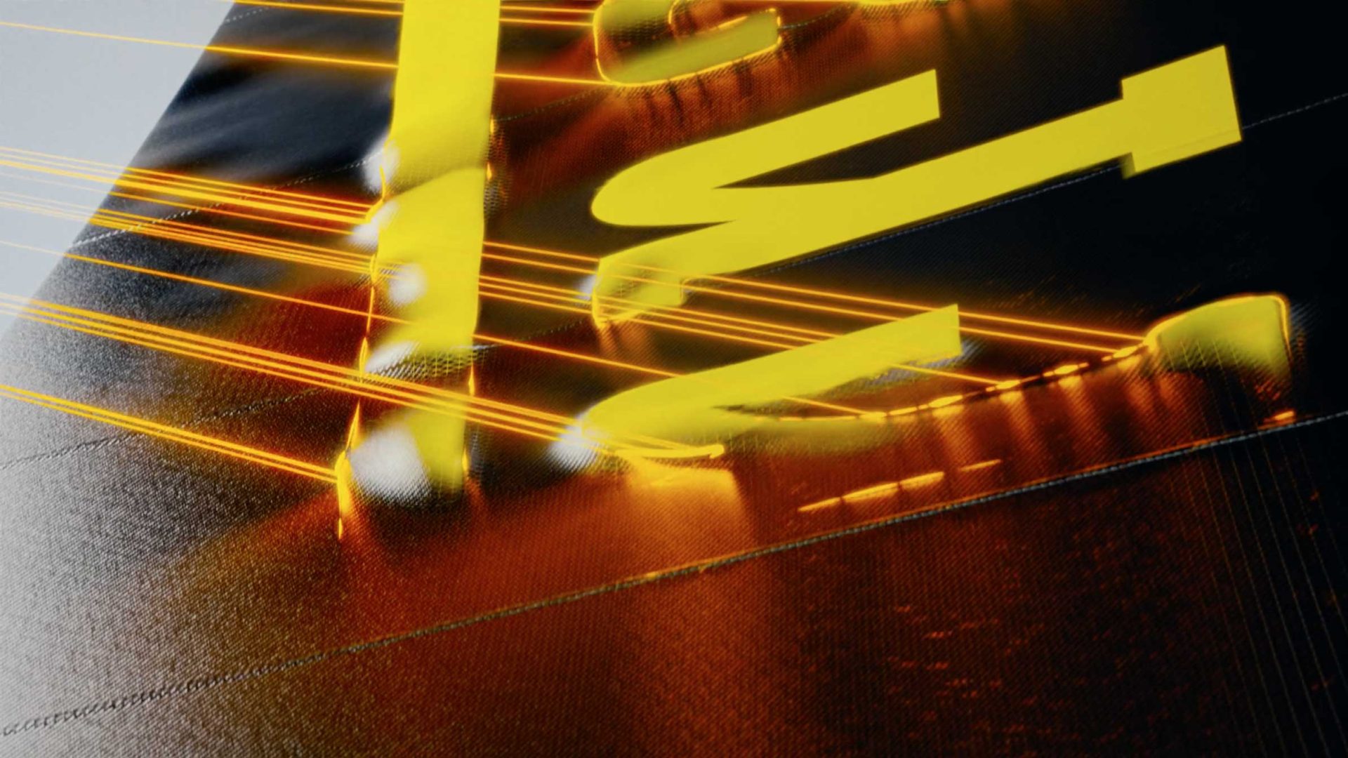 Close-up of shiny yellow letters on a dark surface, illuminated by diagonal bright orange and yellow light streaks, evoking a dynamic and futuristic effect inspired by the energy of Milan Design Week. Frame from Stash Magazine article.