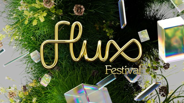 Gold text reading Flux-Festival-2026 appears over a lush background of green grass, flowers, and floating iridescent geometric shapes, creating a vibrant and modern festival theme. Frame from Stash Magazine article.