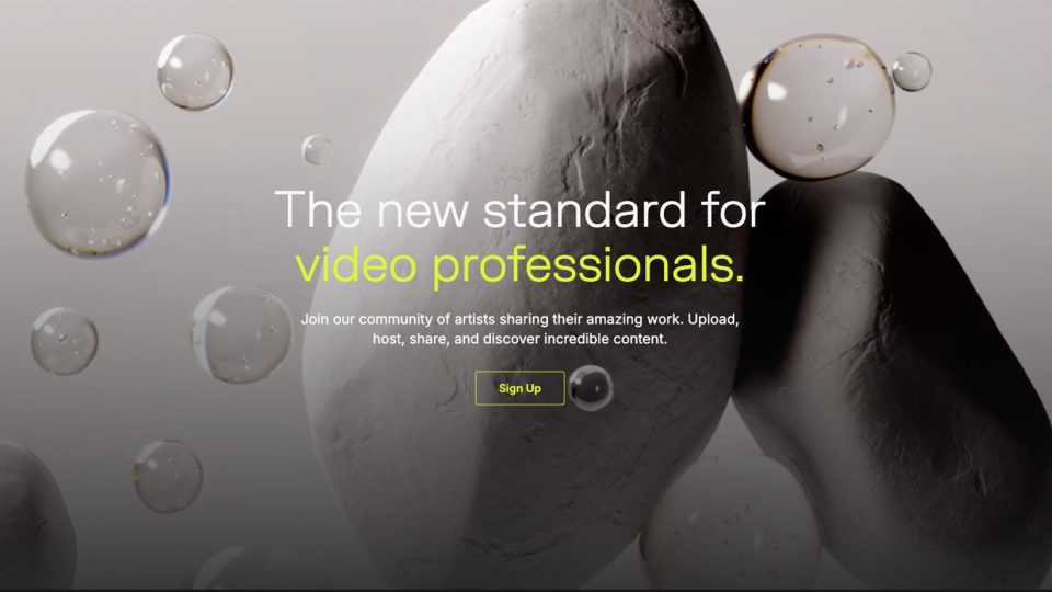 A website landing page with the text The new standard for video professionals, showcasing FrameRate as a Vimeo alternative, over a background of white stones and floating bubbles, with a highlighted Sign Up button below the text. Frame from Stash Magazine article.