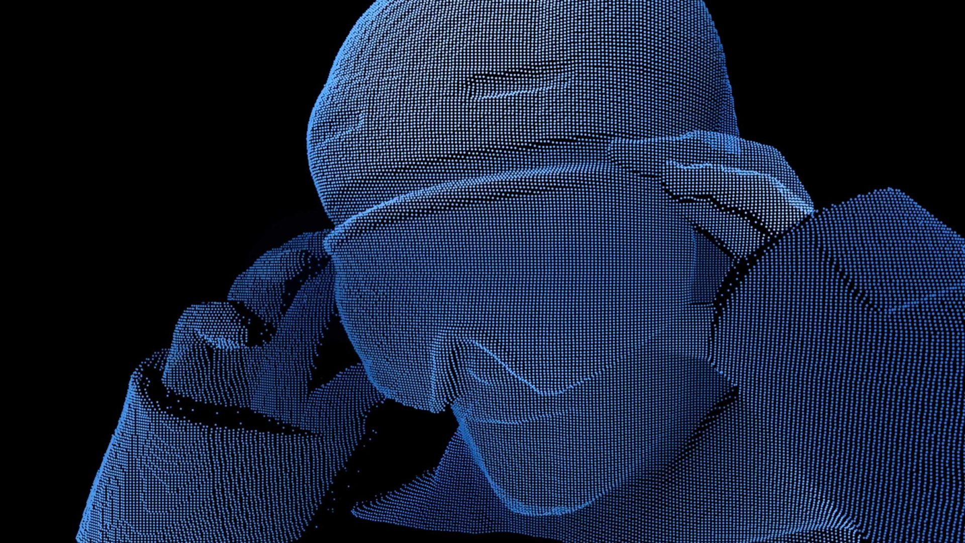 A digital rendering of a person made of blue dots adjusting virtual reality goggles, set against a black background, evokes the cutting-edge innovation behind Team USA’s Motion Reel powered by Google Cloud. Frame from Stash Magazine article.