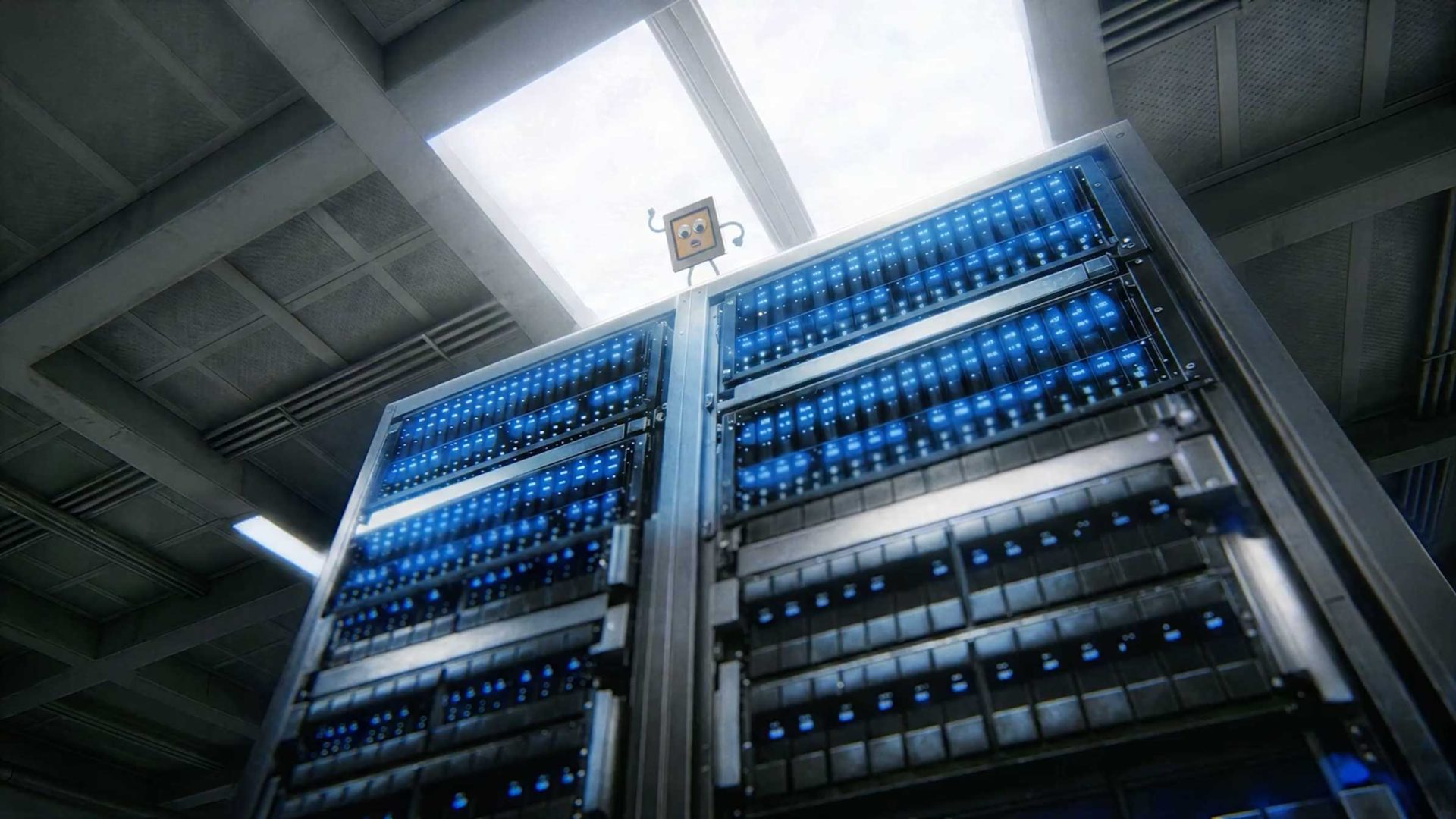 A small, cartoon character inspired by Laurie Rowan stands atop tall server racks glowing with blue lights in a modern, industrial-looking server room, reminiscent of Google I/O, with a skylight above. Frame from Stash Magazine article.