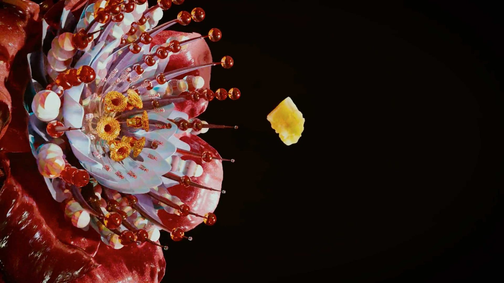 A colorful, highly detailed flower inspired by Gucci’s The Alchemist’s Garden blooms in red, purple, and yellow against a black background. A small yellow pollen clump floats in midair near the flower’s center. Frame from Stash Magazine article.