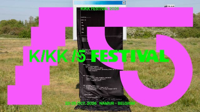 A large pink 15 and green text reading KIKK 15 FESTIVAL overlay a photo of a grassy field with a black fabric covered in code, embodying experimentation. Event details 23-25 OCT. 2026, NAMUR - BELGIUM are displayed at the bottom. Frame from Stash Magazine article.