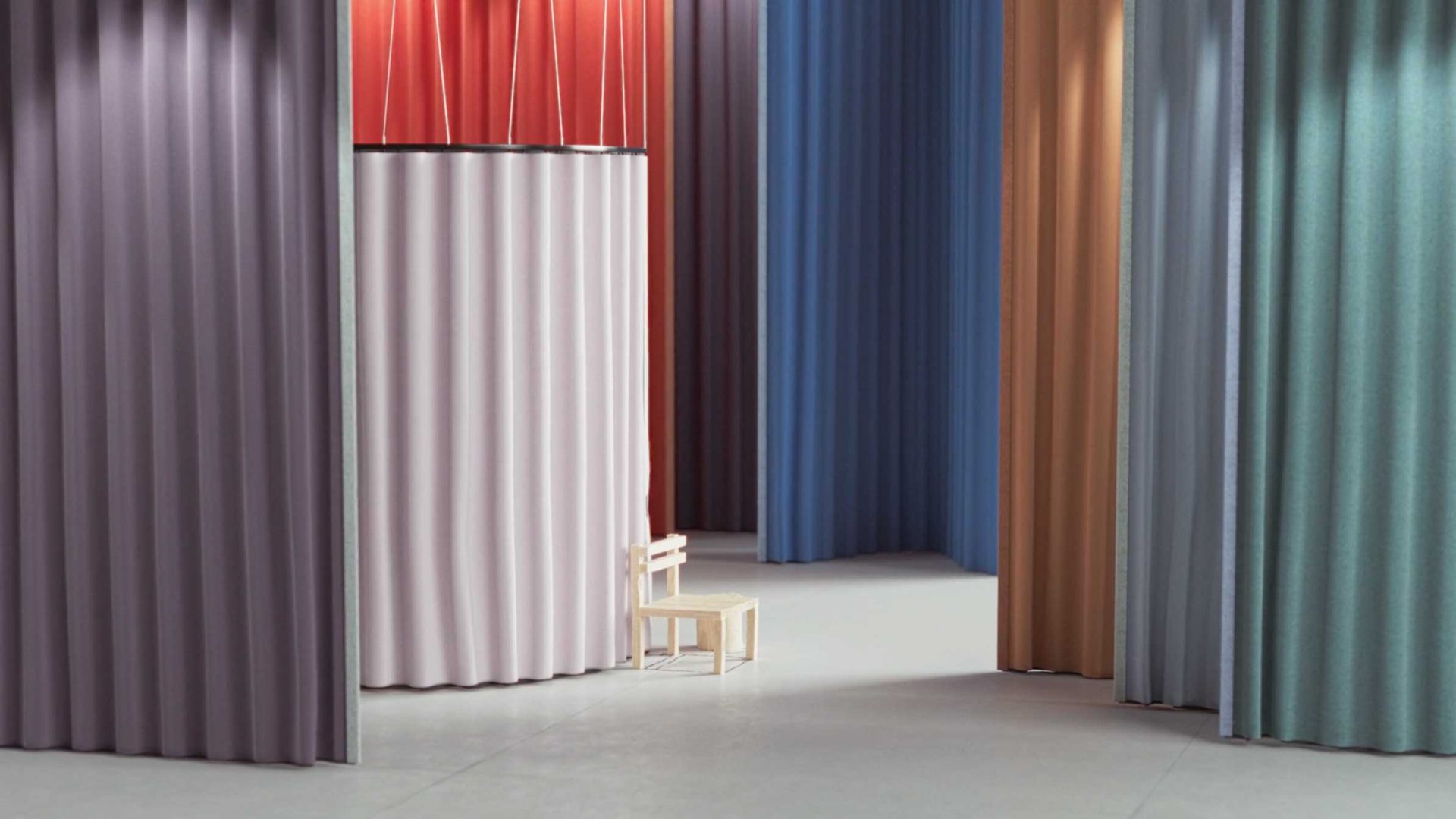 A small wooden chair sits in front of tall, wavy Kvadrat curtains in shades of purple, red, blue, orange, and green, creating a modern and abstract interior scene. Frame from Stash Magazine article.