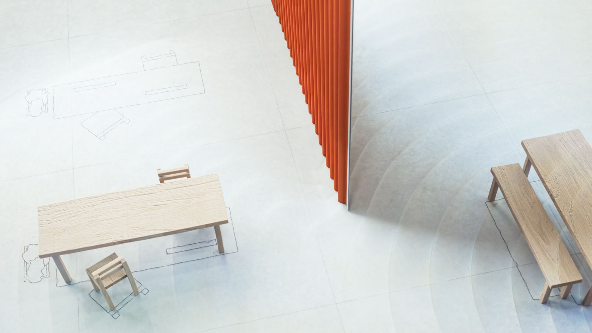 Minimalist room with light wooden tables and benches, a red vertical divider, Kvadrat Waves Curtain, and outlines of furniture sketched on the light floor—an aesthetic captured in the product film by Frame, viewed from above. Frame from Stash Magazine article.