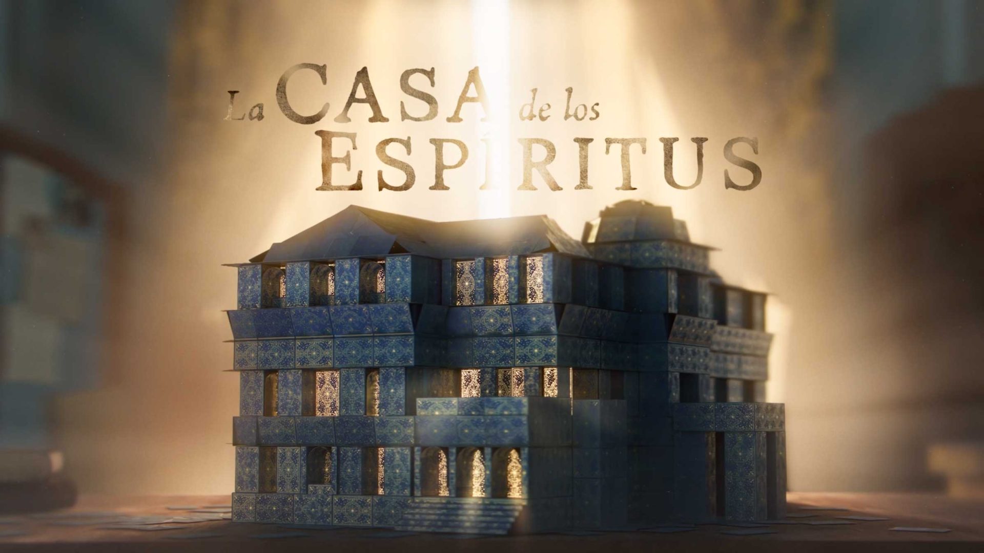 A three-story, blue-tiled building is illuminated by a beam of light, with the Spanish text La Casa de los Espíritus appearing above it in a glowing, ethereal style—now streaming on Amazon Prime Video. Frame from Stash Magazine article.