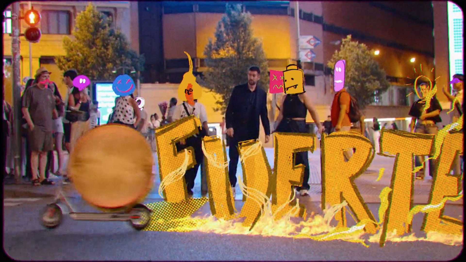 A group of people with cartoon faces stand in a city street at night behind large, fiery yellow letters spelling FIVER as a person on a scooter rides past. Channeling the spirit of Character & Chaos, the scene bursts with energy and unpredictability, while trees and buildings are visible in the background. Frame from Stash Magazine article.