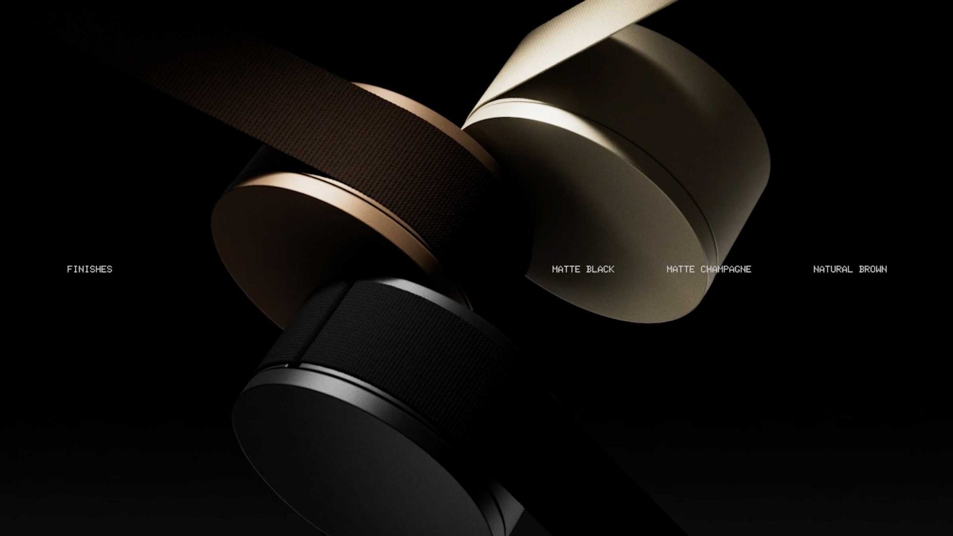 Three cylindrical lighting products from the Lodes MAP collection by jformento are shown in matte black, matte champagne, and natural brown finishes, positioned against a black background with corresponding labels for each color. Frame from Stash Magazine article.