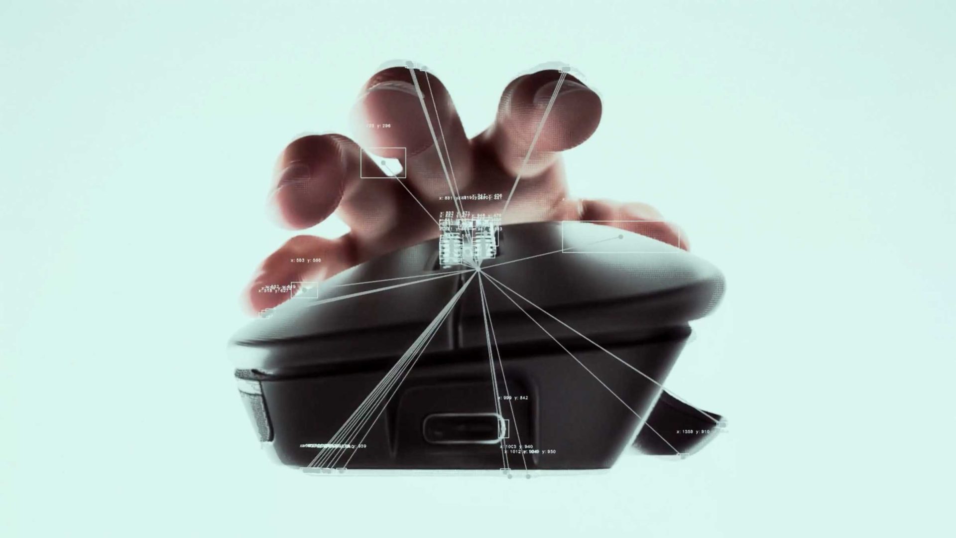 A hand gripping a Logitec MX Master 4 mouse, with digital lines and data overlays illustrating technological connectivity and interaction. Frame from Stash Magazine article.