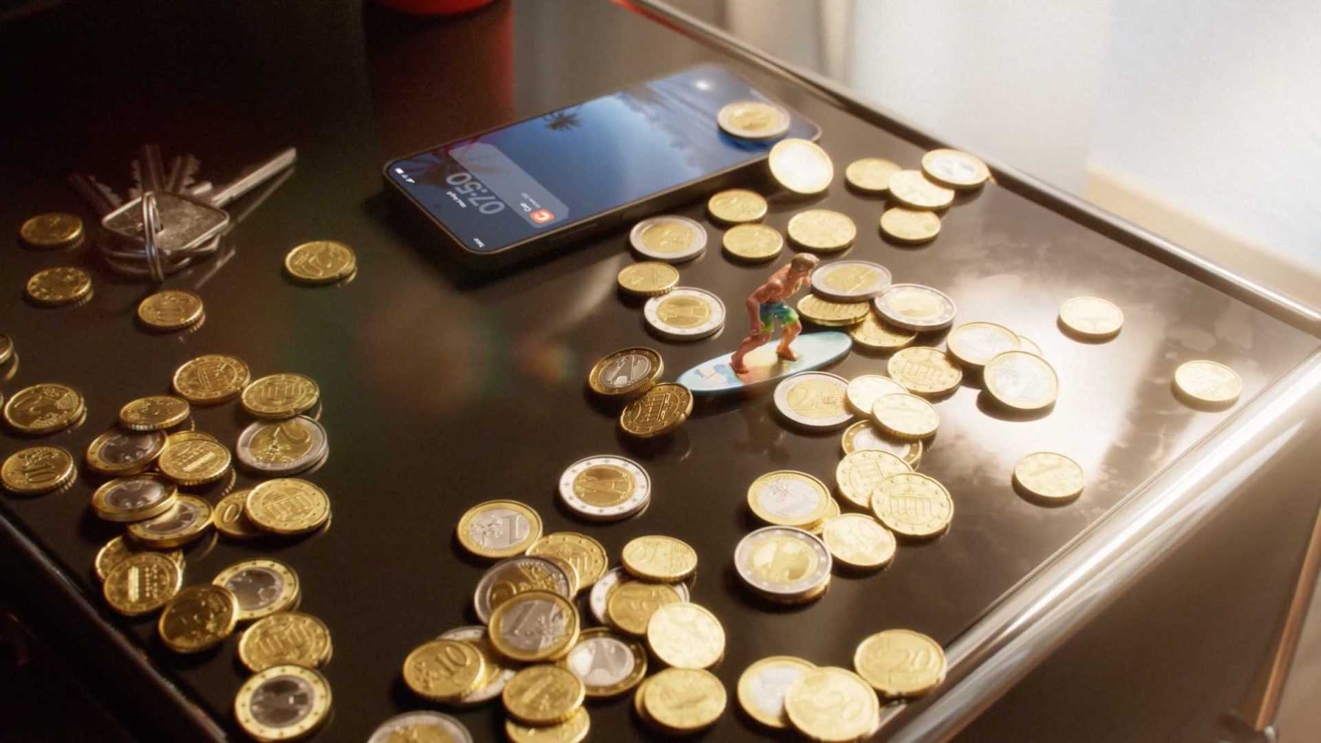 A tabletop covered in gold coins, keys, a smartphone—displaying the latest Fintech updates—and a tiny figurine of a surfer on a coin. Sunlight streams in from the right side, illuminating every crumb of detail in this spec spot scene. Frame from Stash Magazine article.