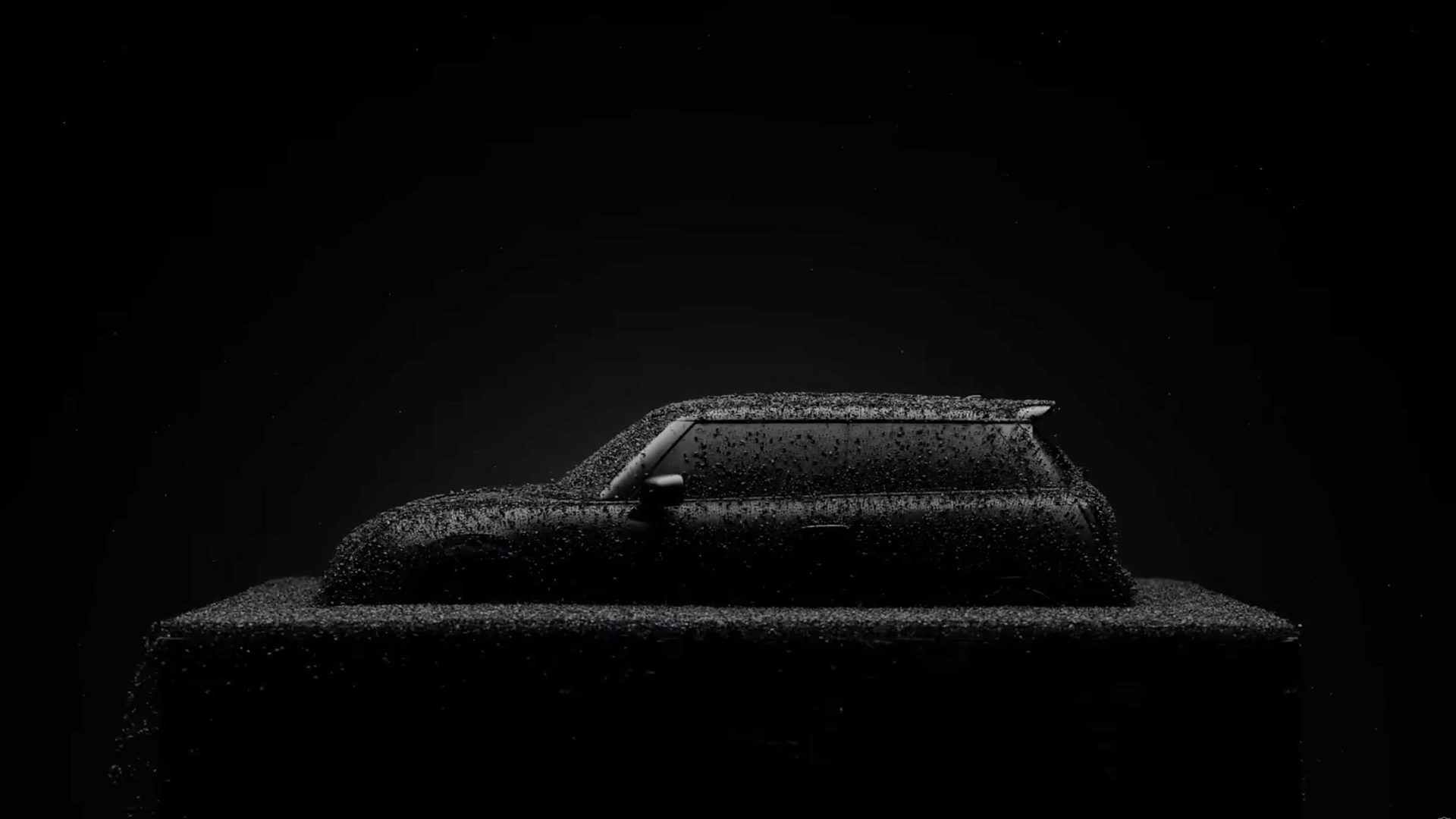 A black car covered in water droplets is shown in profile view against a dark background, showcasing its outline with a minimal and dramatic lighting effect—evoking the allure of Special Editions like MINI Icon Drops. Frame from Stash Magazine article.
