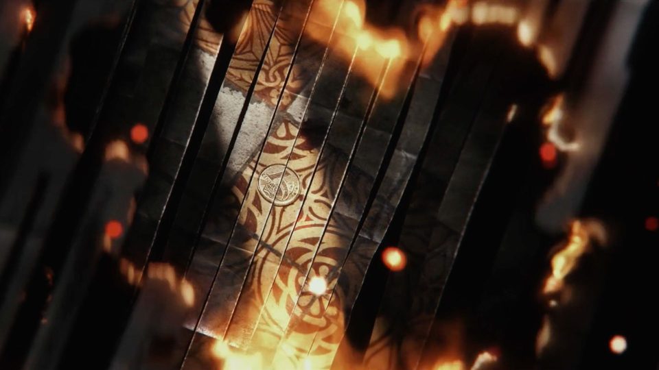 A top-down view of a metallic surface with intricate golden patterns, surrounded by dark panels and glowing orange flames, evokes the intense atmosphere of Man on Fire’s Main Titles for Netflix. Frame from Stash Magazine article.