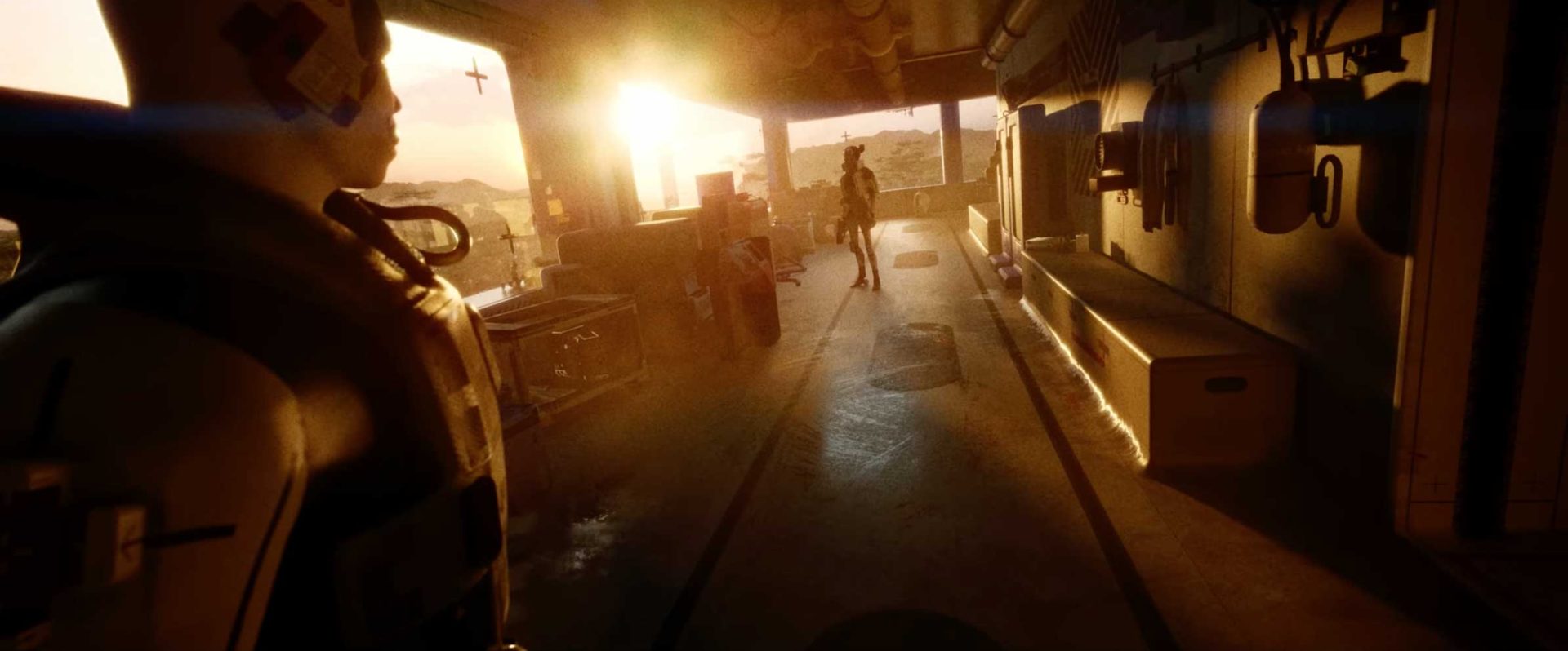 A sunlit room with industrial equipment and a mannequin in the foreground; in the background, a person stands near the open entrance as "Death We've Just Begun" by Son Lux echoes and bright sunlight reveals a desert landscape outside. Frame from Stash Magazine article.