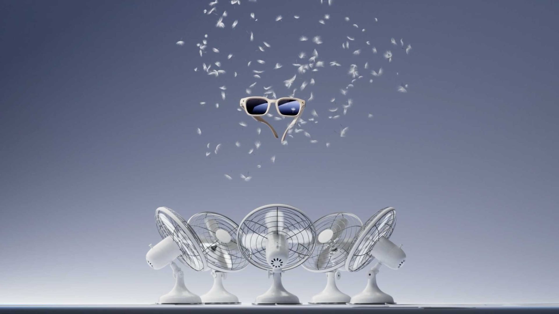 Five table fans blow feathers upward towards a pair of floating sunglasses against a plain background, evoking the whimsical energy of the Meta Little Wonders AI Glasses launch films by Builders Club & Tendril. Frame from Stash Magazine article.